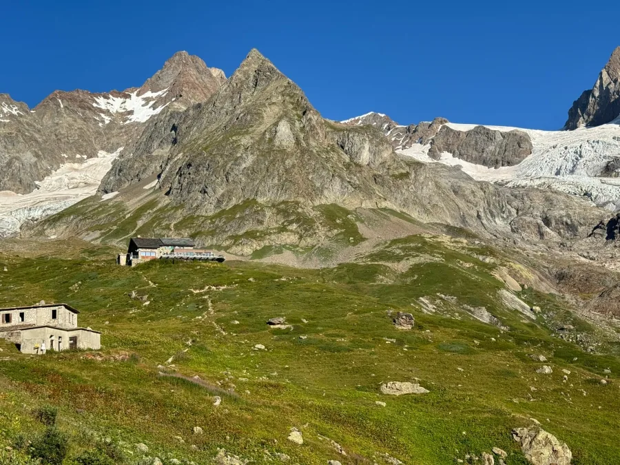 Hikers on the Mont de la Saxe ridge above Courmayeur with the Grandes Jorasses behind